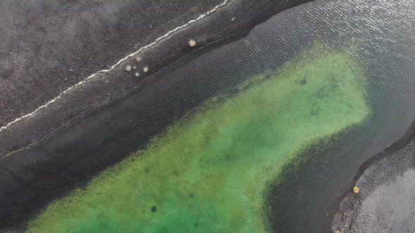 Aerial panoramic view of the green lake in the crater of a volcano on the Atlantic coast.