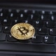 Closeup of a golden bitcoin medal on a black keyboard. - VideoHive Item for Sale