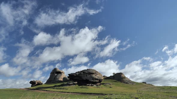 Huge Stone Boulder Against the Blue Cloudy Sky