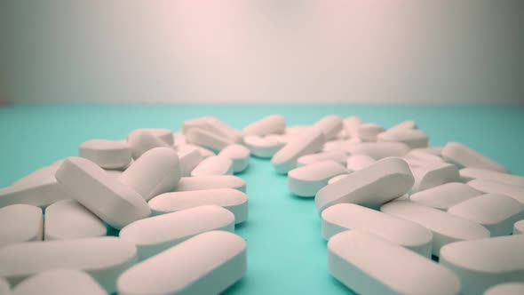 Extreme Closeup in Motion of White Pills on a Blue Background As a Concept of the Pharmaceutical