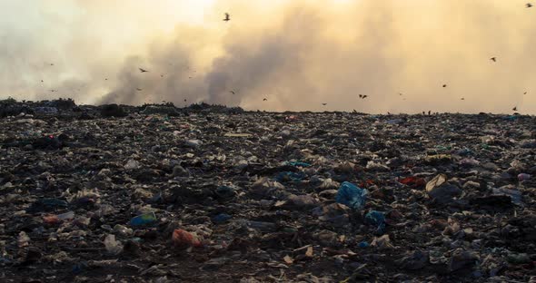 Burning garbage pile in trash landfill