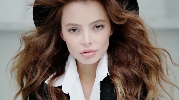 Close-up Portrait of Fashionable Young Woman in Black Hat and Jacket