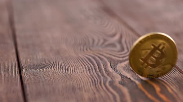 Bitcoin Coin Spinning on Wooden Background  Closeup with Slowmo