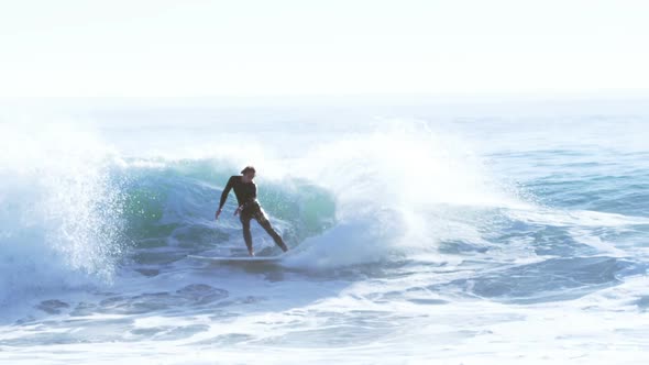 Surfers surfing in sea