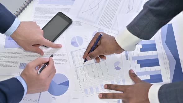 Close Up of Hands of Professional Team Working on Financial Documents