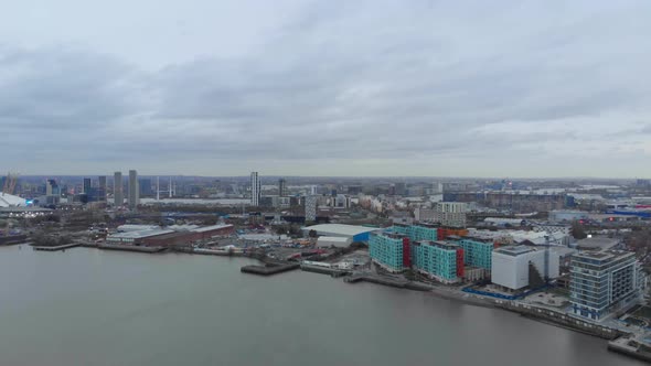 Dolly forward drone shot of Industrial bank of Thames river London