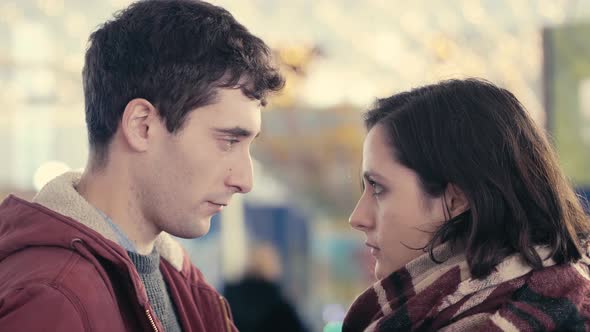 young couple in crisis at christmas time looking sadly at each other