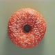 Orange Glazed Donut Rotating on Green Top View - VideoHive Item for Sale