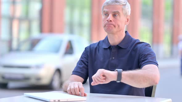 Outdoor Waiting Middle Aged Businessman Checking Time on Smartwatch