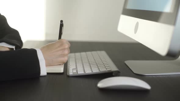 Business Woman Writing Data In Office