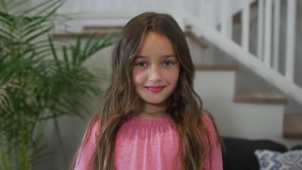 Portrait of caucasian girl looking at camera and smiling