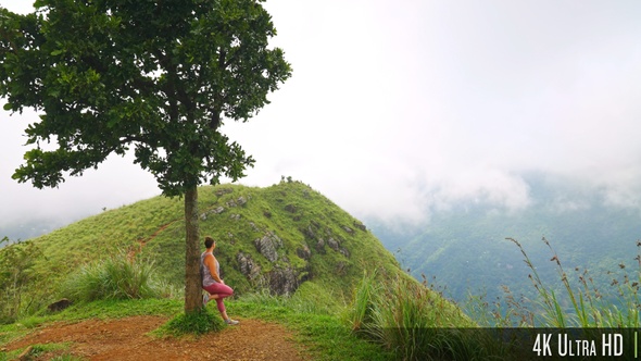 4K Woman Hiker Leaning Against Tree on Mountain Range Trail