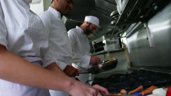 Team of chefs chopping vegetables and preparing food