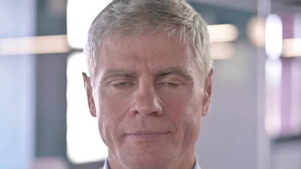 Close Up of Serious Middle Aged Man Looking at Camera