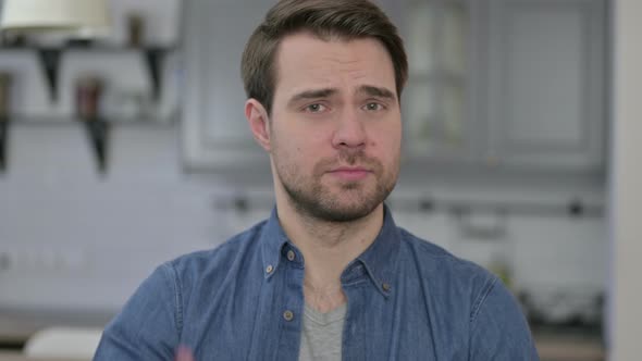 Portrait of Beard Young Man Saying No By Finger Sign