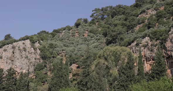 Group of tourist cruising on traditional boat through stone valley on the river at Dalaman Stream