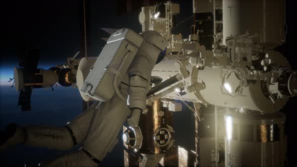 International Space Station and Astronaut in Outer Space Over the Planet Earth alt