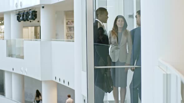 Office Workers Going Up in the Elevator