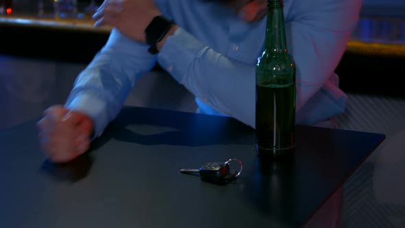 Drunk man sleeping with his head on counter