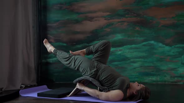 Attractive Plus Size Woman Practicing Yoga in the Studio. Practice for the Treatment of Back Trouble