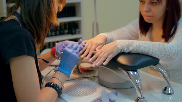 Unknown Manicurist Gives Manicure to Client in Salon