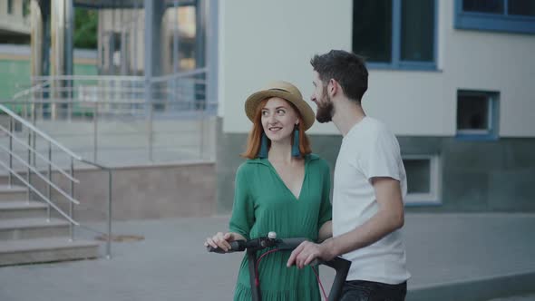 Young Couple in Love Stands in Embraces Kisses Each Other and Has Pleasant Talk