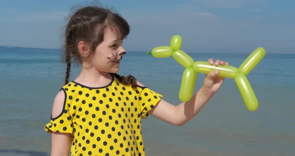 Child with Plastic Toy By Sea