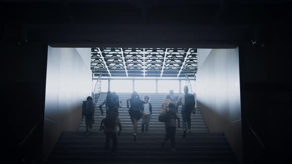 Group Students Running Upstairs Pass Boy Going Opposite Direction