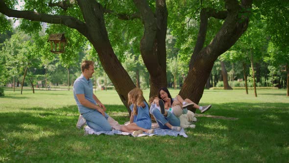 Cheerful Parents Tickling Kids on Picnic