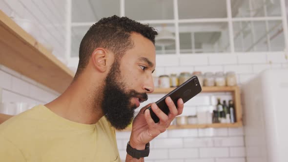 Man talking on smart phone at home