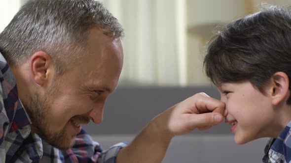 Smiling Father and Son Giving Five, Playing Games, Spending Weekend With Child