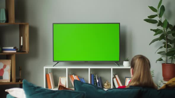 Woman Watching Television with Green Screen
