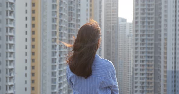 Woman Look at The Apartment Building in City