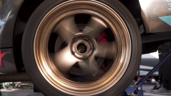 Closeup of Sport Car Gold Color Rotating Wheel