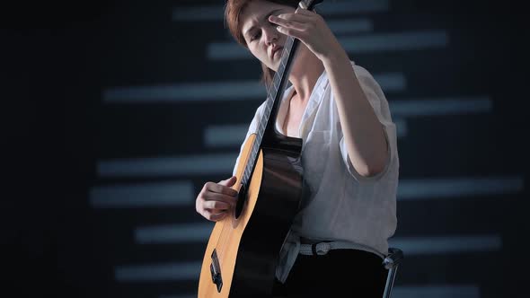 Girl Playing Guitar at Studio