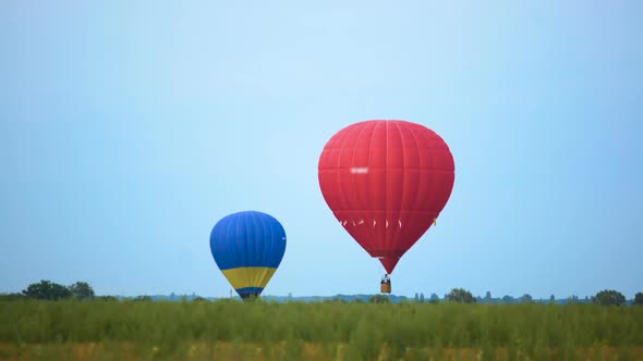 Two Colorful Hot Air Balloons Preparing for Soft Landing, Extreme Sport