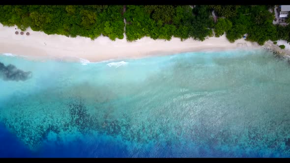 Aerial top down landscape of exotic coast beach journey by aqua blue lagoon and white sandy backgrou