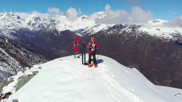 Aerial: Hiker on mountain top, ski touring mountaineering snow mountain winter sport