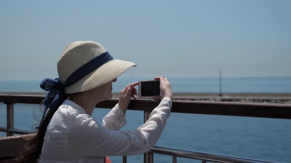 Lady Makes Video of Beautiful Seascape Sailing Past Pier