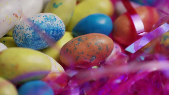 Rotating shot of colorful Easter candies on a bed of easter grass 