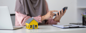 Muslim businesswoman dealing with real estate, buying and selling houses and insurance for real
