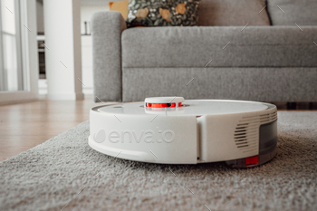 Smart home concept.closeup of robot vacuum cleaner in the living room.copy space banner