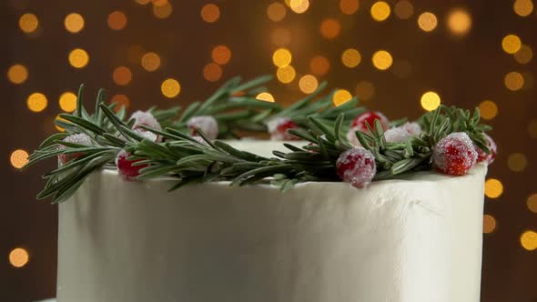 Panorama of the Christmas White Cream Cake with Cranberries and Rosemary Wreath