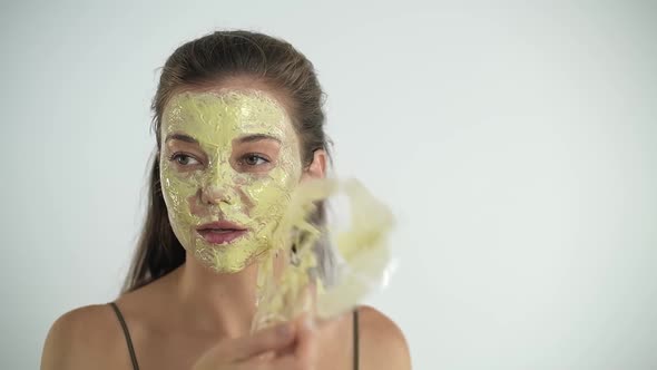 The Girl Removes the Mask From Her Face with a Sponge