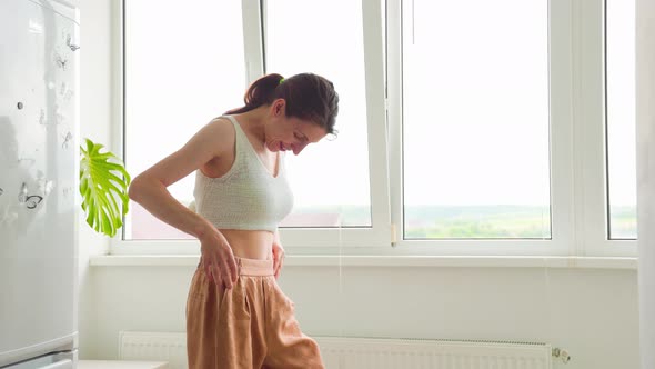 Slim Surprised Happy Woman Body in Big Pants