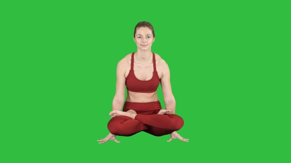 Tolasana or Scale Pose Beautiful woman do Yoga sitting