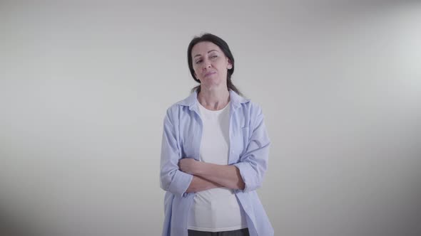 Portrait of Adult Proud Caucasian Woman Looking Away with Sarcastic Smile. Ironical Lady Standing on