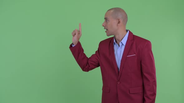 Happy Bald Multi Ethnic Businessman Touching Something and Giving Thumbs Up