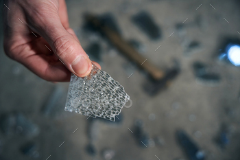 Worker holds a piece of triplex glass in his hands