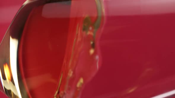 Vertical video, Close-up: red wine is poured into a glass